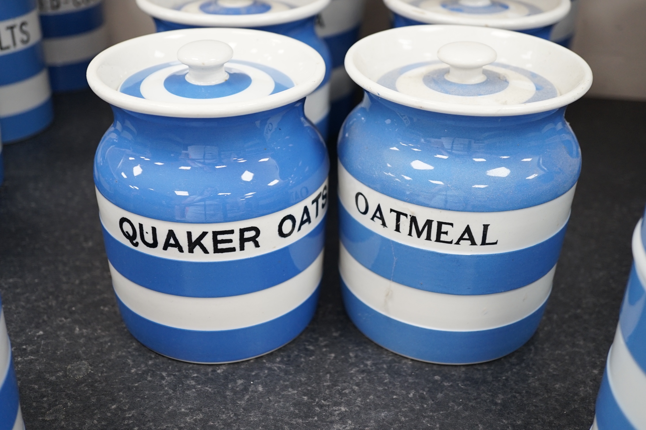 T.G.Green Cornish Kitchenware, eight lidded storage jars comprising Washing-Soda, Soda, Starch, Haricot Beans, Quaker Oats, Oatmeal, Lentils and one unnamed, largest 18cm high, mainly Black Shield marks. Condition - fair